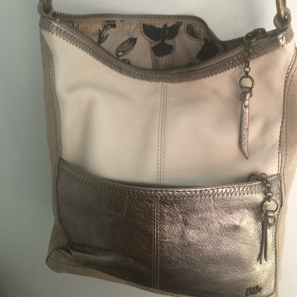 The Sak Metalic and Cream Crossbody